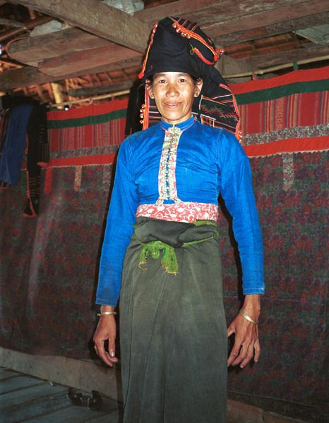 54K Jpeg Black Thai woman stanging in front of curtain room dividers separating sleeping from living areas in a Black Thai (Tai Dam) house in Dien Bien Phu, Lai Chau province photographed in October 1995.