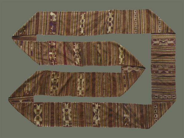 Jpeg 59K From Xam Tai, this unusual mosquito net border (now in the collection of Pamela Cross) is a lovely shade of brown, with accents of purple, gold and yellow. It is unusual because of the design motifs: elongated, stylized star motifs with arrows; also present in a few places are stylized animal motifs and figures with up-raised hands. One end is a dark red rather than brown. It is all handspun cotton (or perhaps fine hemp?) with cotton and some silk supplementary weft. Condition is very good, tho there are soiled areas throughout. Size: 274" (22'-10") x 9.5" 