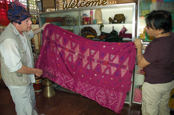Jpg 63K Nick Fielding examining an old silk malong at the Aljamelah Inaul Weaving and Sewing Center - Mindanao, 2007 