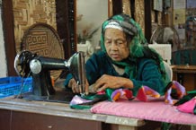 to 52K Jpg Assembling pieces of satin fabric on an old Singer sewing machine at the Aljamelah Inaul Weaving and Sewing Center - Mindanao, 2007