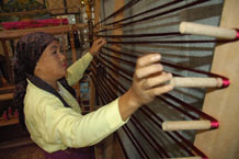 to Jpg 56K Winding threads in the warping frame before warping up a loom at the Aljamelah Inaul Weaving and Sewing Center - Mindanao, 2007