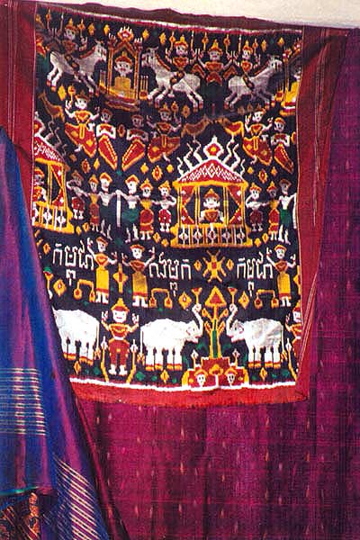 ss11 Jpeg 56K At my sister's - a pidam with "kampuchea" written on it. Under it, a Burmese sarong, on either side, new Khmer silk ikat.