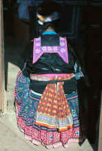 to Jpeg 35K Back view of a Blue Hmong woman showing collar, sash and skirt 881200a