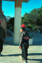 to Jpeg 25K Blue Hmong boy walking through Wat Doe Suthep 8812l24