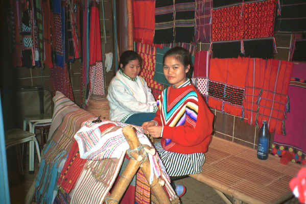 Two Karen girls selling traditional hand-woven clothing in the night market in Chiang Mai in northern Thailand 8812i05.jpg