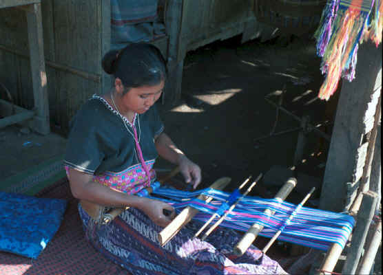 Sgaw Karen woman weaving at her backstrap loom dressed in a traditional hand-woven blouse 8812o36A.jpg