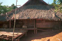 to Jpeg 36K U Lo-Akha house showing basket on the verandah in a village in the hills around Chiang Rai 8812p18.jpg