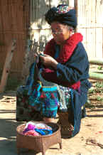to Jpeg 37K A Yao woman working on her embroidery in a village in the hills around Chiang Rai 8812q10.jpg