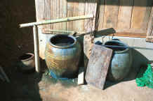to Jpeg 27K Large earthenware pots holding indigo dye liquid in a Yao village in the hills around Chiang Rai 8812q11.jpg