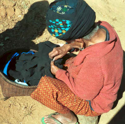 An old Yao lady sitting in the sun sewing a gusset into a jacket 8812q18.jpg
