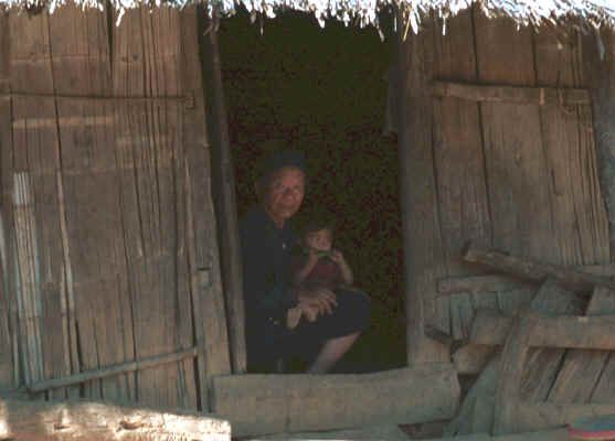 A Yao grandfather and his grandchild peering out from the darkness of a house 8812q26.jpg