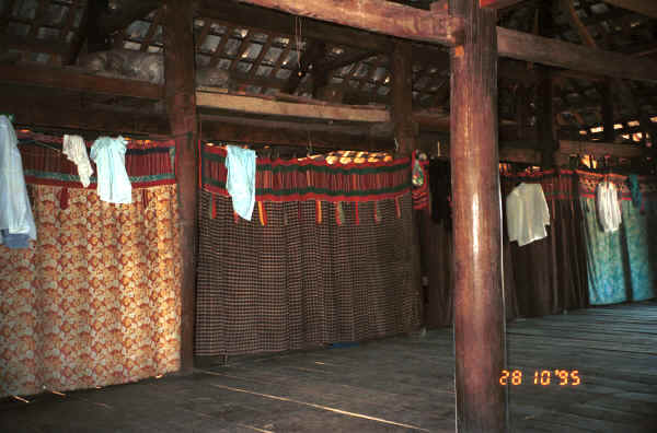 Jpeg 31K Curtains separating off the sleeping areas from each other and from the living area in a Black Thai House.  Note the hand woven material in several curtain headings as well as patchwork.  Dien Bien Phu.  Lai Chau Province. 9510C36.JPG