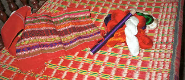 Jpeg 34K A woven bag and some cotton and silks for the supplementary weft as shown in the weaving.  They had been dyed by the Black Thai weaver from dyes (probably chemical) bought locally.  Note the edges of the seat cushion made from a similar length of weaving.  Dien Bien Phu, Lai Chau Province 9510D01.JPG