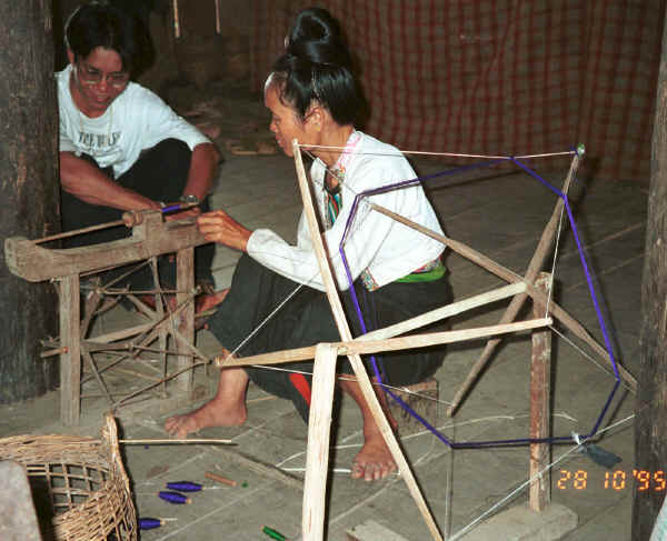 Jpeg 36K Black Thai lady winding dyed thread - probably silk - onto a bobbin before weaving.  Village near Dien Bien Phu, Lai Chao Province 9510E14.JPG