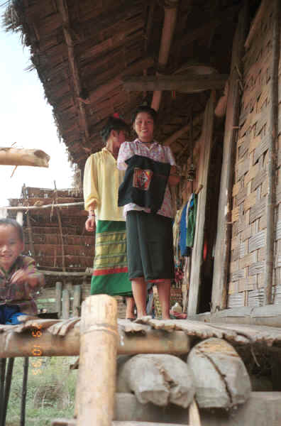 Jpeg 28K Black Thai young woman outside her house holding an indigo dyed head cloth which she is embroidering, village near Dien Bien Phu, Lai Chao Province 9510F20.JPG