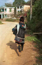 to Jpeg 31K Black Hmong Woman carrying her baby home from Sa Pa, Lao Cai Province in an embroidered and batiked baby carrier  9510I23.JPG