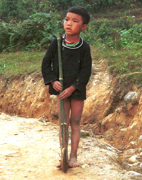 Jpeg 47K Young Black Hmong boy with a bamboo stick with a wheel inserted in it's end in the hills around Sa Pa, Lao Cai Province 9510I29.JPG