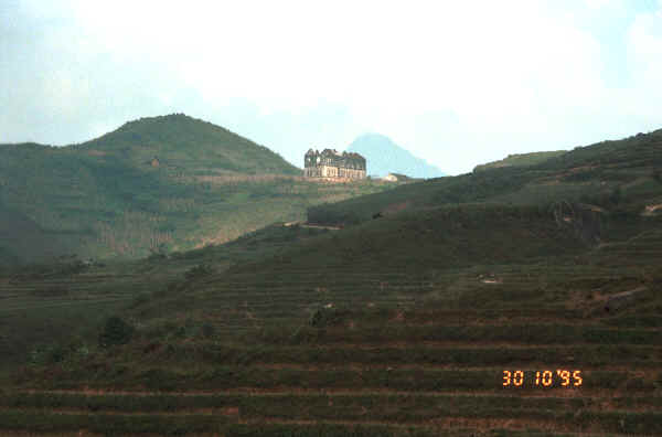 Jpeg 13K A ruined church left from the French occupation in the hills around Sa Pa, Lao Cai Province.  Note the terraced fields in the foreground.