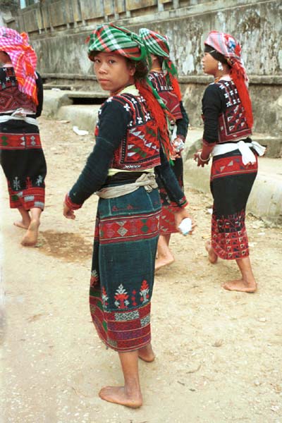 47K Jpeg 9510I14 Four very shy Phula, Xa Pho girls in Sa Pa, Lao Cai Province, north west Vietnam. Note the wool embroidery on the blouse and skirts with Jacob's tear seeds on the blouses.