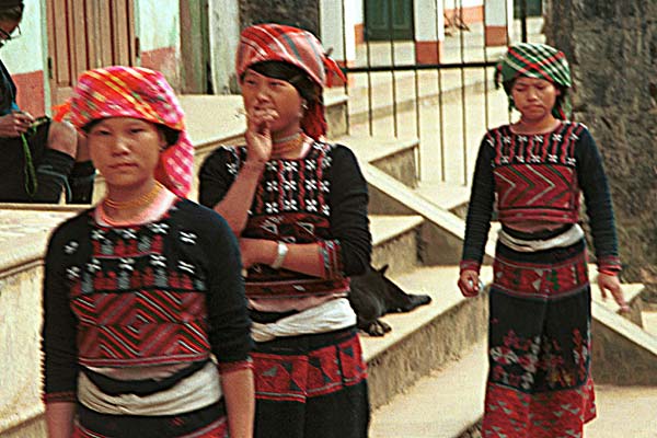 53K Jpeg 9510I16a Three very shy Phula, Xa Pho girls in Sa Pa, Lao Cai Province, north west Vietnam. Note the wool embroidery on the blouse and skirts with Jacob's tear seeds on the blouses. 