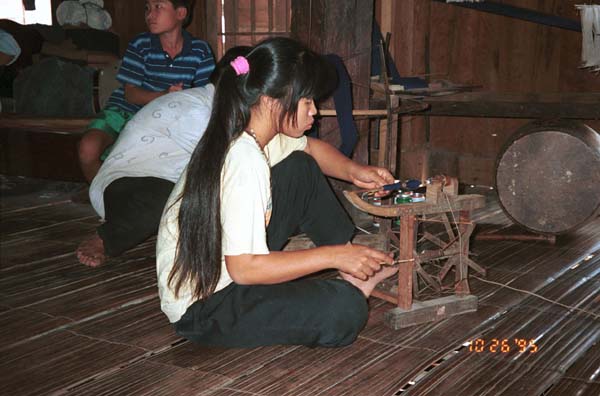 Girl winding bobbins for weaving in Ban Lac village, Mai Chau District in Hoa Binh Province near the border with the north-western part of Thanh Hoa Province in north west Vietnam 9510A10E