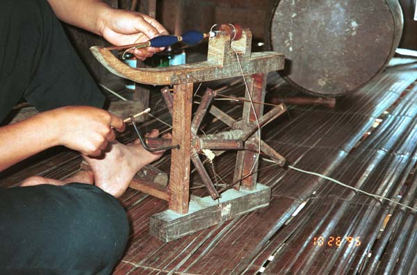 Girl winding bobbins for weaving in Ban Lac village, Mai Chau District in Hoa Binh Province near the border with the north-western part of Thanh Hoa Province in north west Vietnam 9510A11E